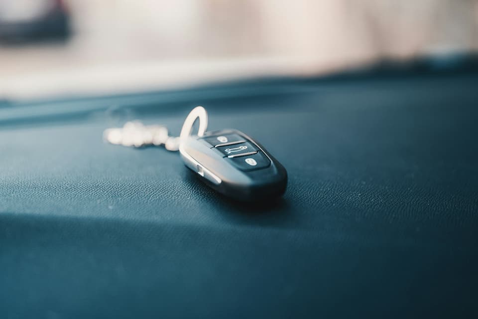 A car key fob resting on a car dashboard